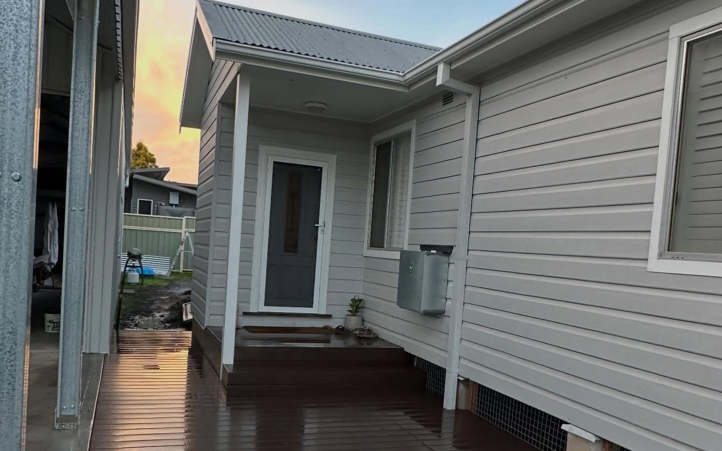 Entry and deck at golden hour on a Hunter outdoor living job